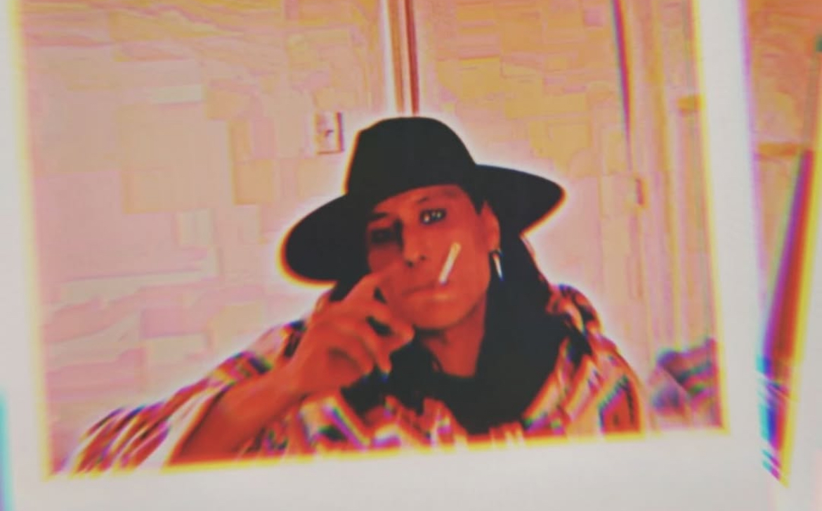 Gilduske in a black hat, photographed through an acid-trip color treatment